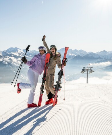 Junge Leute feiern im neuen Großarler Bergrestaurant "Skylounge Wolke 7" mit Blick auf die tiefverschneite Berglandschaft.